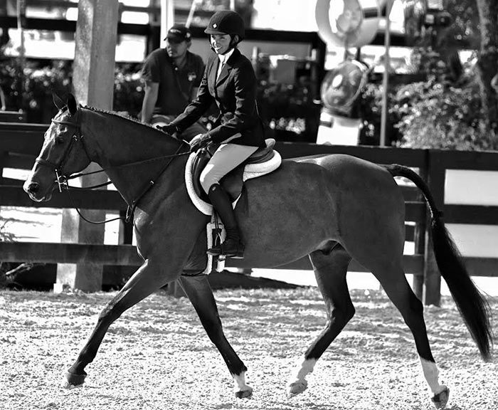 Grayson Schirmer riding horseback (black and white photo)