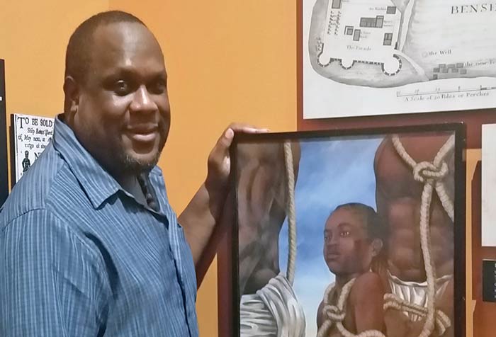 Dana Coleman stands next to a canvas gicleé of "Priscilla" on Sullivan’s Island